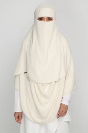 Full niqab covering the face with a sheer fabric, leaving only the eyes visible.